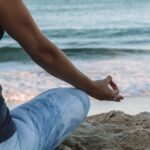 Woman meditating at the beach