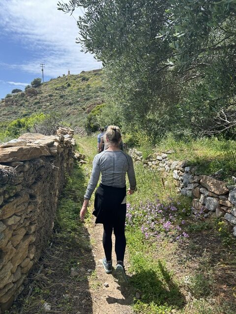 Paige hiking a mountain trail surrounded by trees